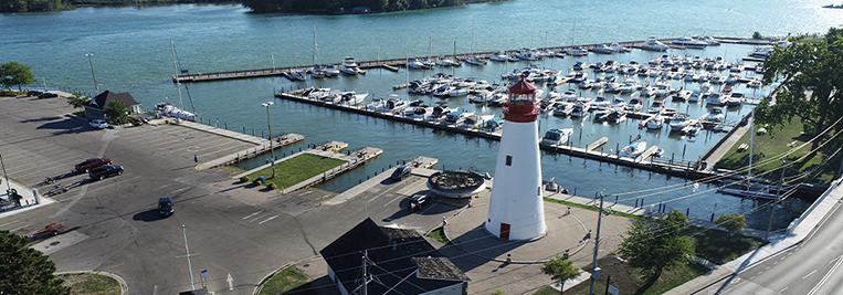 Aerial view of lighthouse and marina from the west